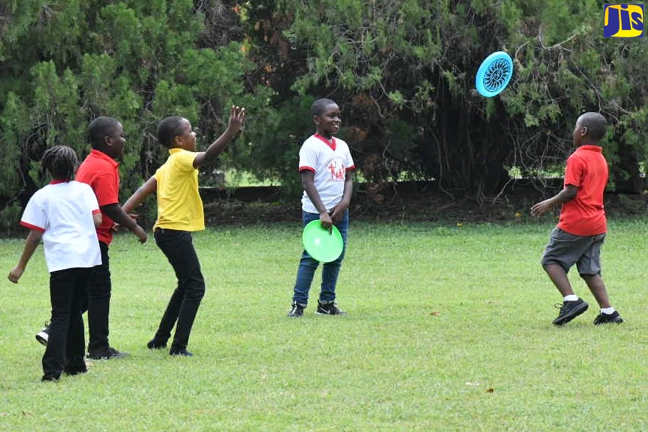 Children enjoying a game of frisbee at the Hope Royal Botanic Gardens in St. Andrew recently. The facility is marking 150 years in 2023.