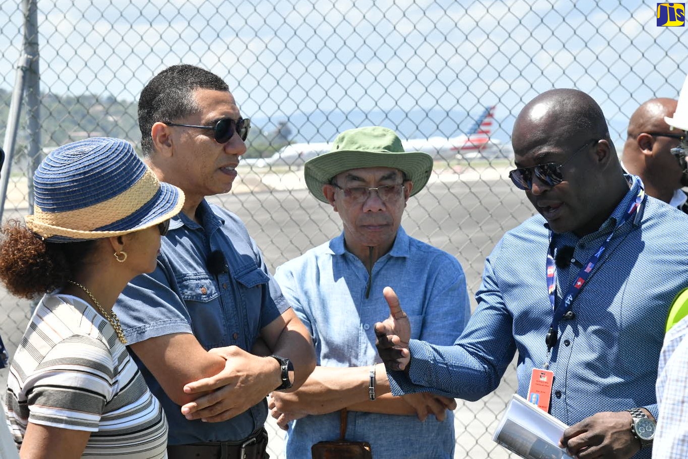 Prime Minister, the Most Hon. Andrew Holness (second left), is briefed on the progress of the Sangster International Airport runway extension project by Chief Executive Officer of MBJ Airports Limited, Shane Munroe (right), during a tour of the facility in Montego Bay, St. James, on Saturday (April 1). Also listening are Deputy Prime Minister and Minister of National Security, Hon. Dr. Horace Chang (second right), and Minister of Legal and Constitutional Affairs, Hon. Marlene Malahoo Forte. 