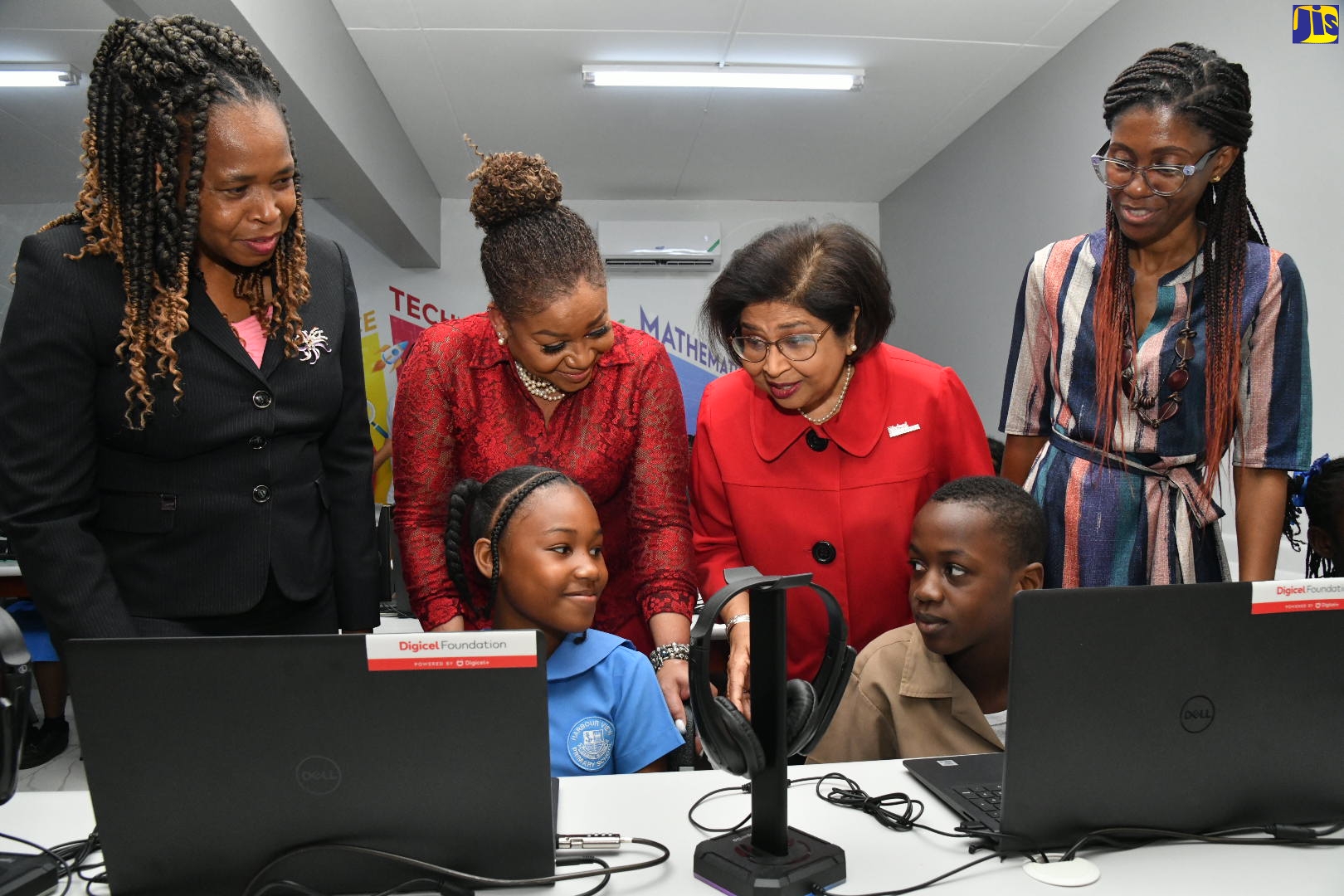 Digicel Foundation Chair, Jean Lowrie-Chin (second right, standing), interacts with students at the Harbour View Primary School during the opening of a smart room at the institution on Tuesday (April 4). The state-of-the-art facility was provided by the Foundation. Also sharing the moment are (from left, background) Acting Regional Director, Region 1, Ministry of Education and Youth, Dasmine Kennedy; Digicel Foundation Board Member, Heather Moyston and Teacher at the school, Janet Bruce-Shea.