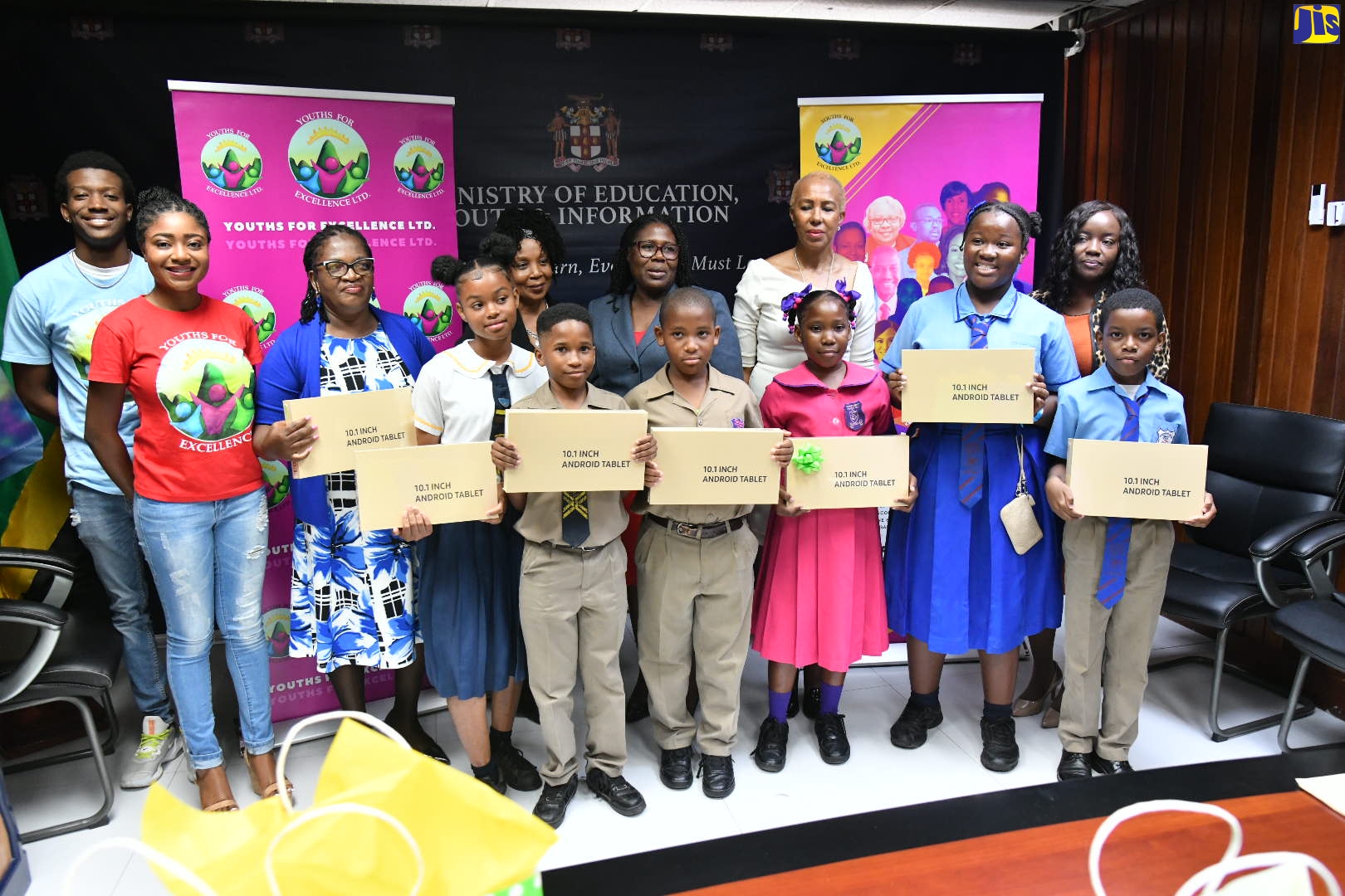 Minister of Education and Youth, Hon. Fayval Williams (fourth right), shares in the presentation of tablets to teachers and students of the Windward Road Primary and Junior High, and Treadlight and Rollington Town Primary schools, at a ceremony for the handover of tablets donated by the Toots Foundation, at the Ministry’s Heroes Circle offices in Kingston on April 5. Sharing the moment is Vice President of the Toots Foundation, Leba Hibbert (fifth left), daughter of the late reggae icon for whom the foundation is named. The tablets are intended to help bridge the digital divide.