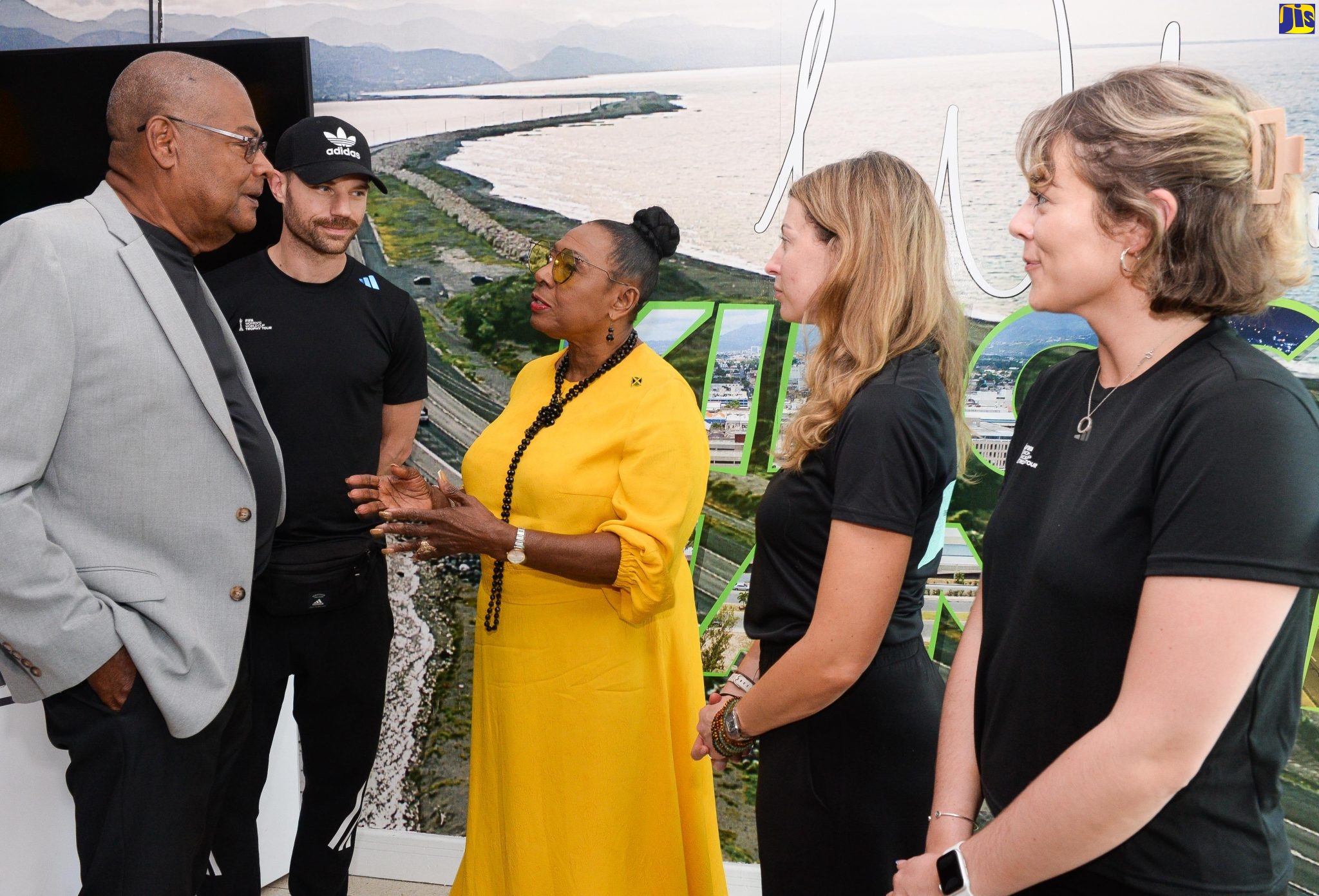 Minister of Culture, Gender, Entertainment and Sport, Hon. Olivia Grange (centre), shares in conversation with President of the Jamaica Football Federation (JFF), Michael Ricketts, following the arrival of the FIFA Women’s World Cup Trophy at the Norman Manley International Airport in Kingston on April 16. Others from (second left) are Communications, FIFA, Vincent Chirol; Senior Trophy Tour Manager, FIFA, Sarah Gandoin; and Communications, FIFA, Ellie Owen. The Women’s World Cup Trophy is to be unveiled on Monday (April 17), during a ceremony at the Jamaica Pegasus Hotel at 9 a.m.