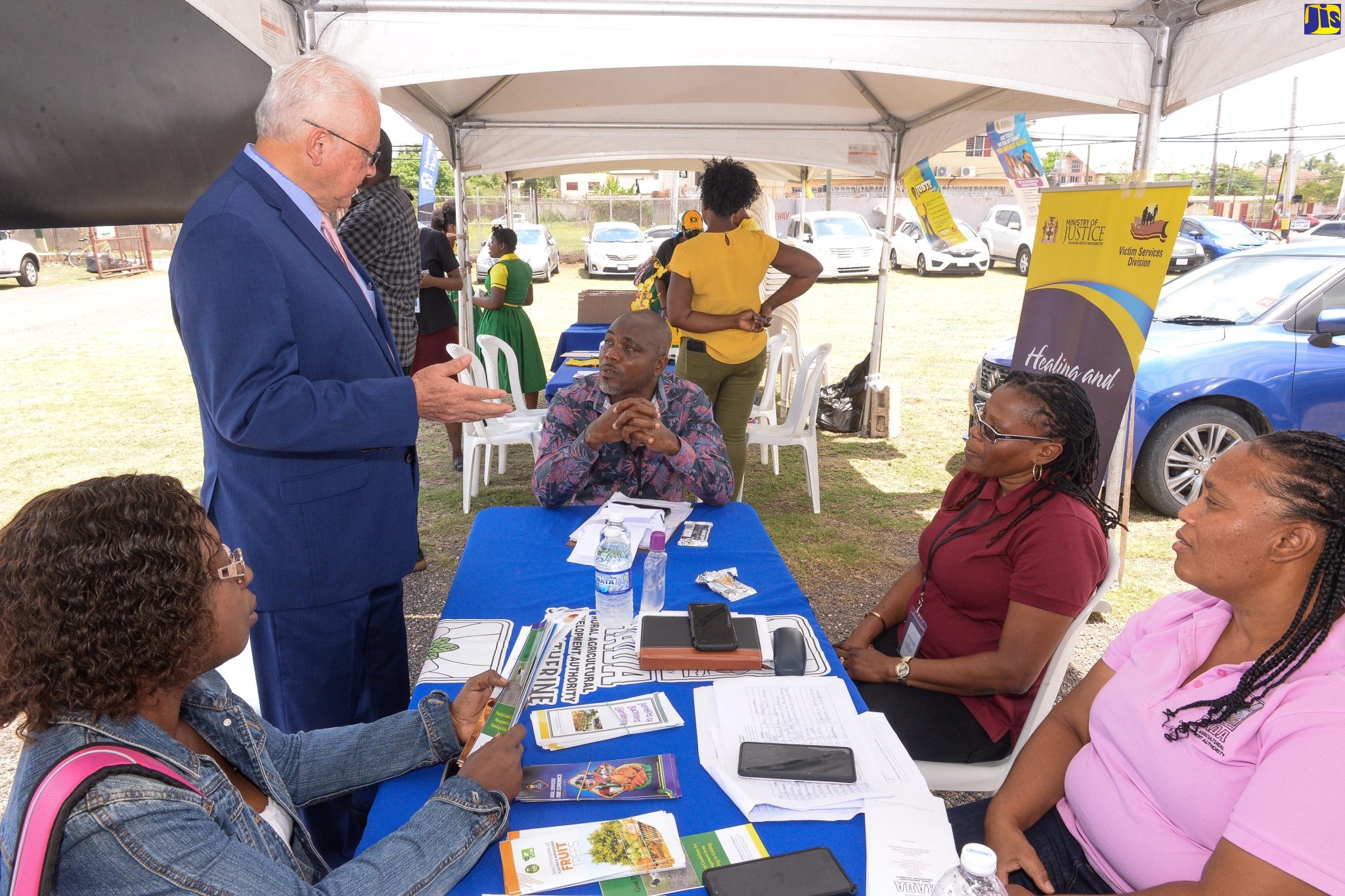 Justice Minister, Hon. Delroy Chuck (left), converses with representatives of the Rural Agricultural Development Authority (RADA) who participated in the Legal Aid Council’s Justice Fair on Friday (March 31). RADA was among several entities mounting booths at the event, which was held in Old Harbour, St. Catherine.
