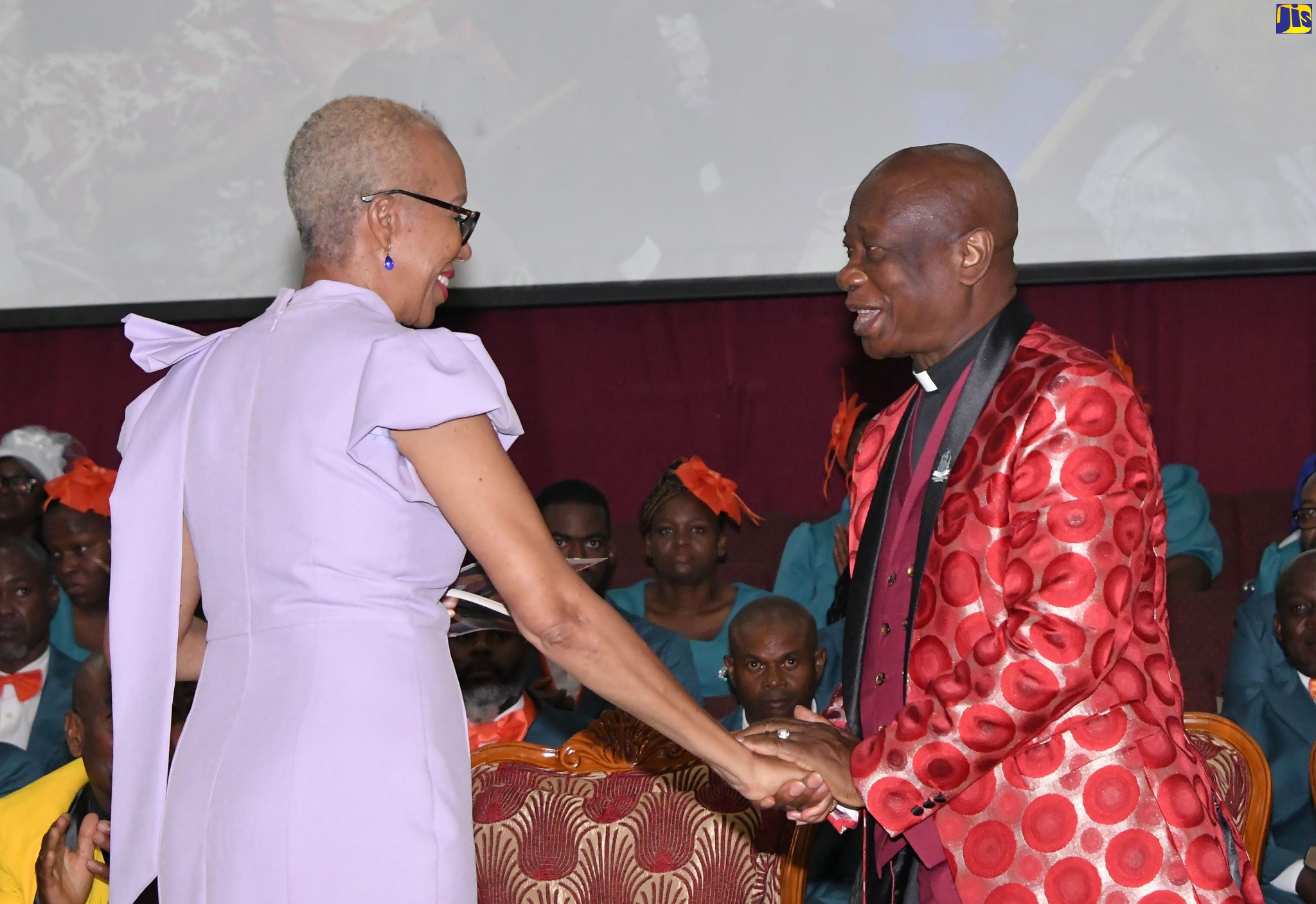 Minister of Education and Youth, Hon. Fayval Williams (left), greets Chairman, Power of Faith Ministries International, Bishop Dr. Delford Davis, at the Power of Faith Ministries International Convention held in Portmore, St. Catherine on April 16.