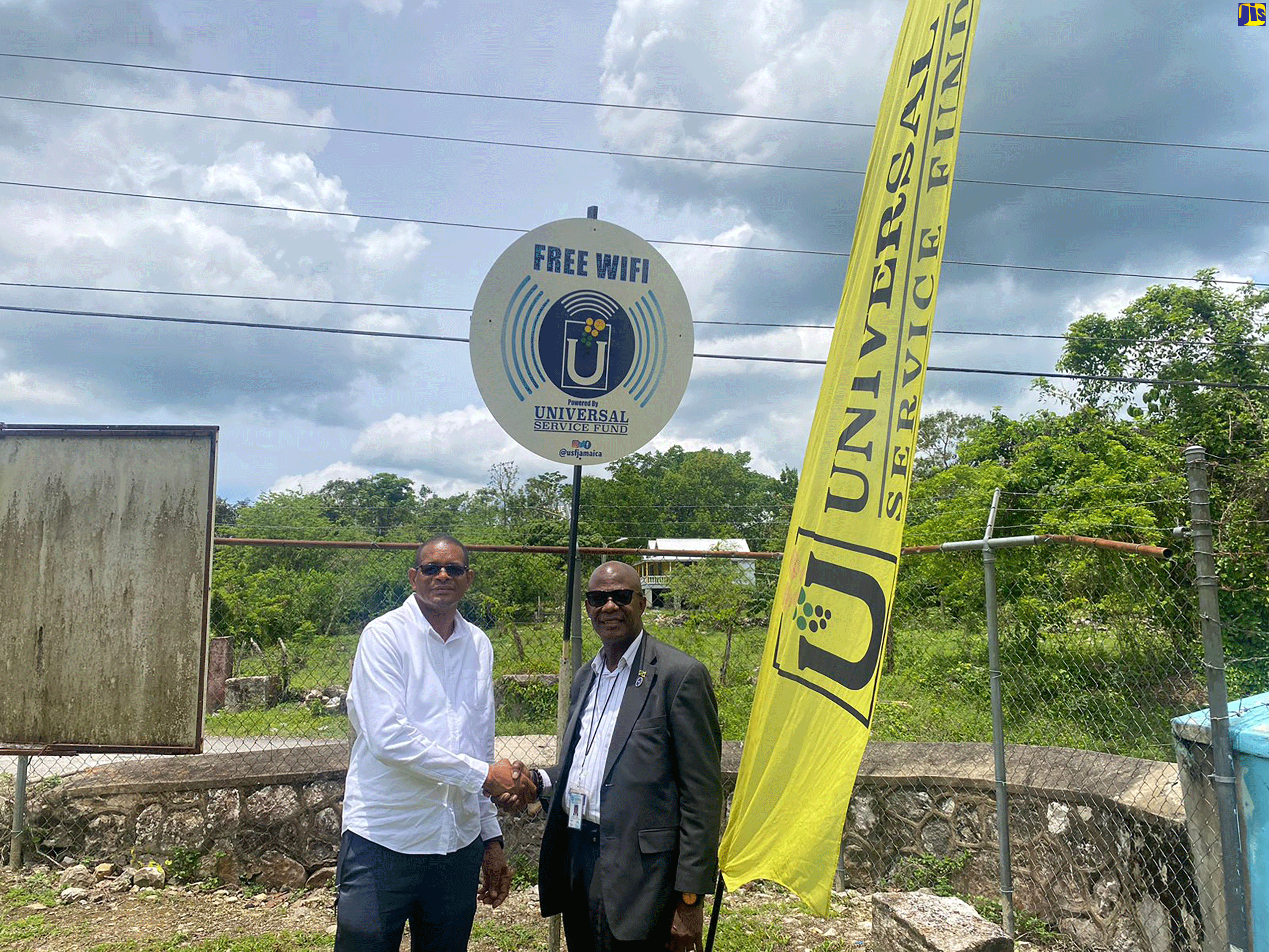Member of Parliament for Hanover Eastern, Dave Brown (left), greets the Chief Executive Officer of the Universal Service Fund, Daniel Dawes, at the commissioning of a Wi-Fi hotspot in Hopewell on April 27.