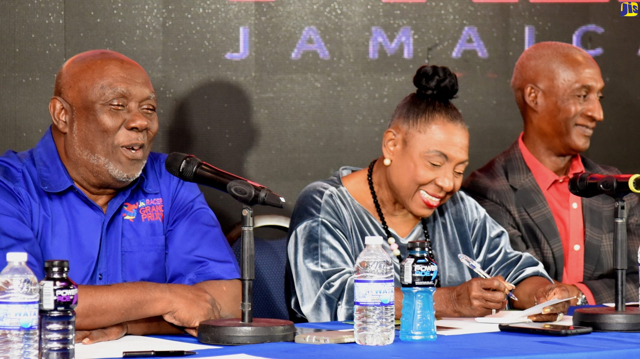 Minister of Culture, Gender, Entertainment and Sport, Hon. Olivia Grange, and   President of the Jamaica Athletics Administrative Association (JAAA), Garth Gayle (right), smile at a comment from Racers Track Club President, Glen Mills at a press conference hosted by Racers on Tuesday (April 4) at the Jamaica Pegasus Hotel in New Kingston. The event was to announce the return of the Racers Grand Prix this year, with a number of high-profile local and international athletes set to compete at the June 3 event at the National Stadium.