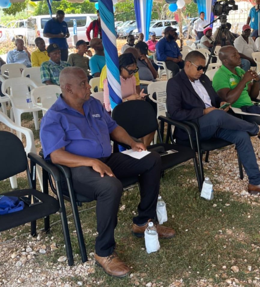 Minister of Agriculture and Fisheries, Hon. Pearnel Charles Jr. (seated, right), listens attentively at the commissioning of the National Irrigation Commission’s (NIC) solar panels in the Beacon Little Park community in St. Elizabeth, on April 12. Also at the ceremony (from left) are Minister of State in the Ministry of Agriculture and Fisheries, Hon. Franklin Witter and Member of Parliament for St. Elizabeth South West, Hon. Floyd Green.