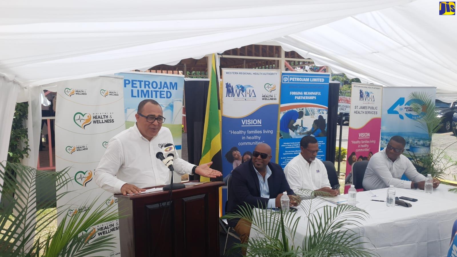 Minister of Health and Wellness, Dr. the Hon. Christopher Tufton (at podium), addresses Friday’s (April 21) ceremony for the adoption of the Montego Bay Comprehensive Type V Health Centre in St. James. The engagement is being facilitated under the Health Ministry’s Adopt-A-Clinic Programme. 