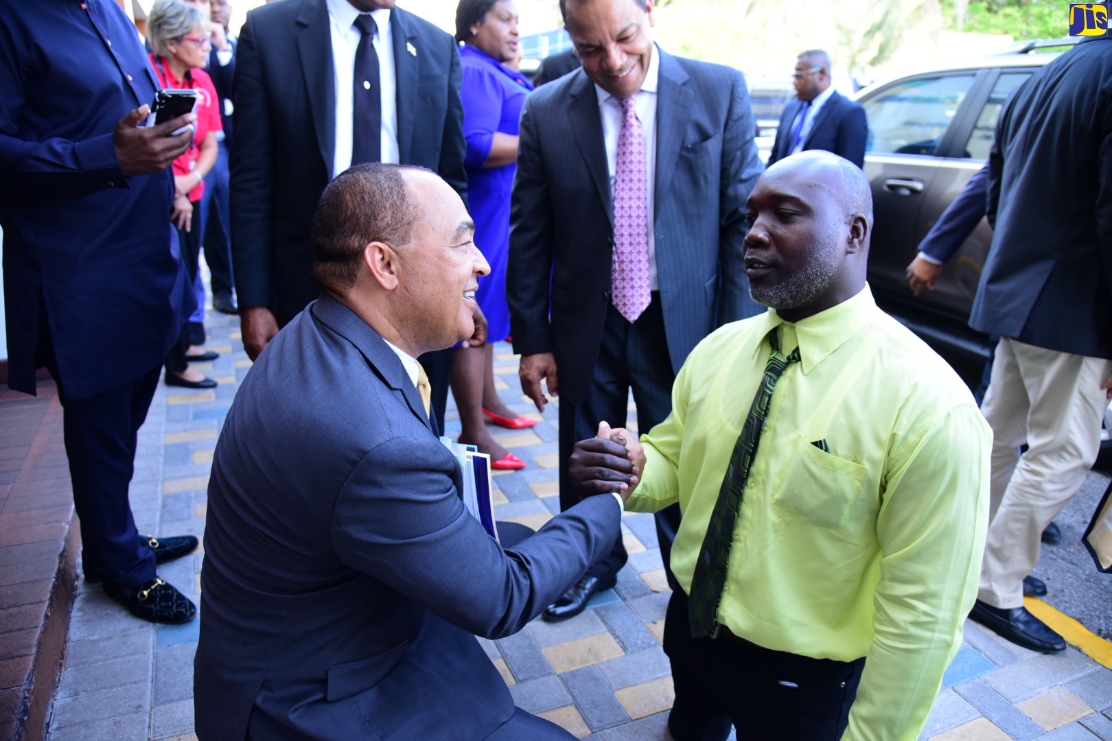 Minister of Health and Wellness, Dr. the Hon. Christopher Tufton (left), greets double amputee and pineapple farmer from Clarendon, Andrew Nelson (right), following the sitting of the House of Representatives on May 3. Mr. Nelson is the first person with a disability to be measured to receive prostheses under the ‘A Prosthetic Partnership Programme for Persons with Disabilities in Jamaica’. The Ministry of Health and Wellness is partnering with the Jamaica Council for Persons with Disabilities (JCPD) on the initiative. Through the collaboration, the Ministry will make $50 million available to provide qualified persons with properly fitted prostheses, enabling them to return to optimal productivity and social participation.