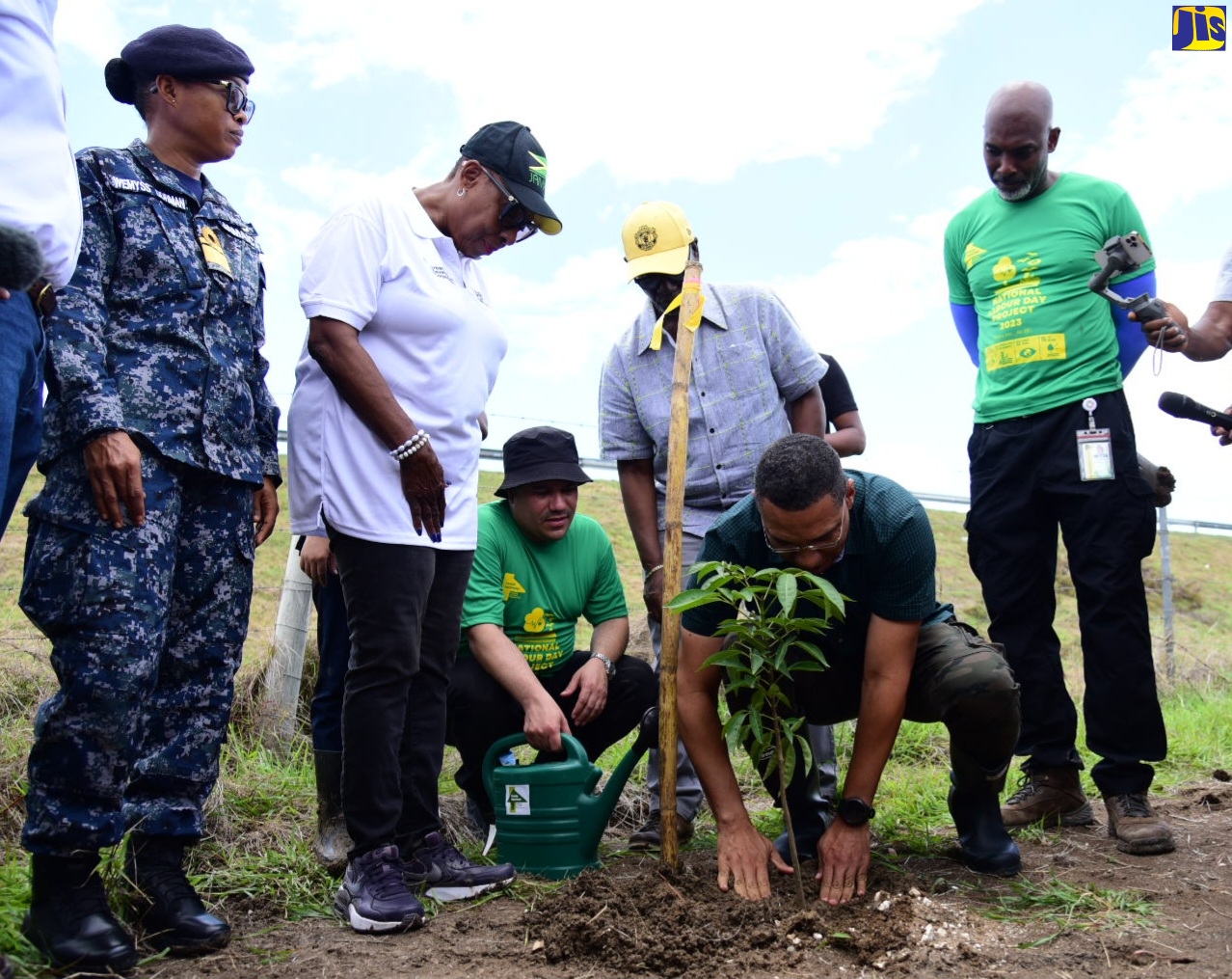 Prime Minister, the Most Hon. Andrew Holness (second right), plants a tree along the P.J. Patterson Highway (Highway 2000), in the vicinity of the Hartlands underpass in the parish of St. Catherine. He is assisted by Minister without Portfolio in the Ministry of Economic Growth and Job Creation, Senator the Hon. Matthew Samuda (third left). Looking on (from left) are Chief of Defence Staff, Rear Admiral Antonette Wemyss Gorman; Minister of Culture, Gender, Entertainment and Sport, Hon. Olivia Grange; Minister of Local Government and Rural Development, Hon. Desmond McKenzie and Chief Executive Officer, Forestry Department and Conservator of Forests, Ainsley Henry.
