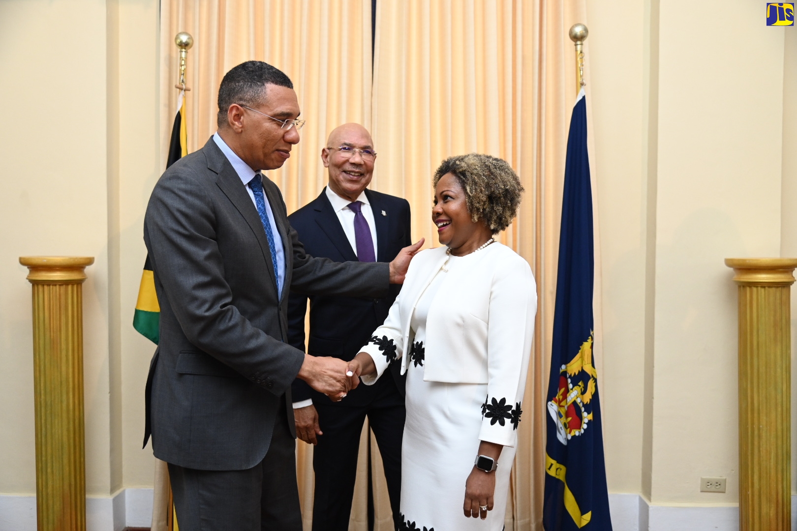 Prime Minister, the Most Hon. Andrew Holness (left), congratulates new Minister without Portfolio in the Office of the Prime Minister, Senator, Dr. the Hon. Dana Morris Dixon (right), after she was officially sworn into office during a ceremony held at King’s House on Thursday (May 25).  Sharing the moment is Governor-General, His Excellency the Most Hon. Sir Patrick Allen, who presided over the ceremony.