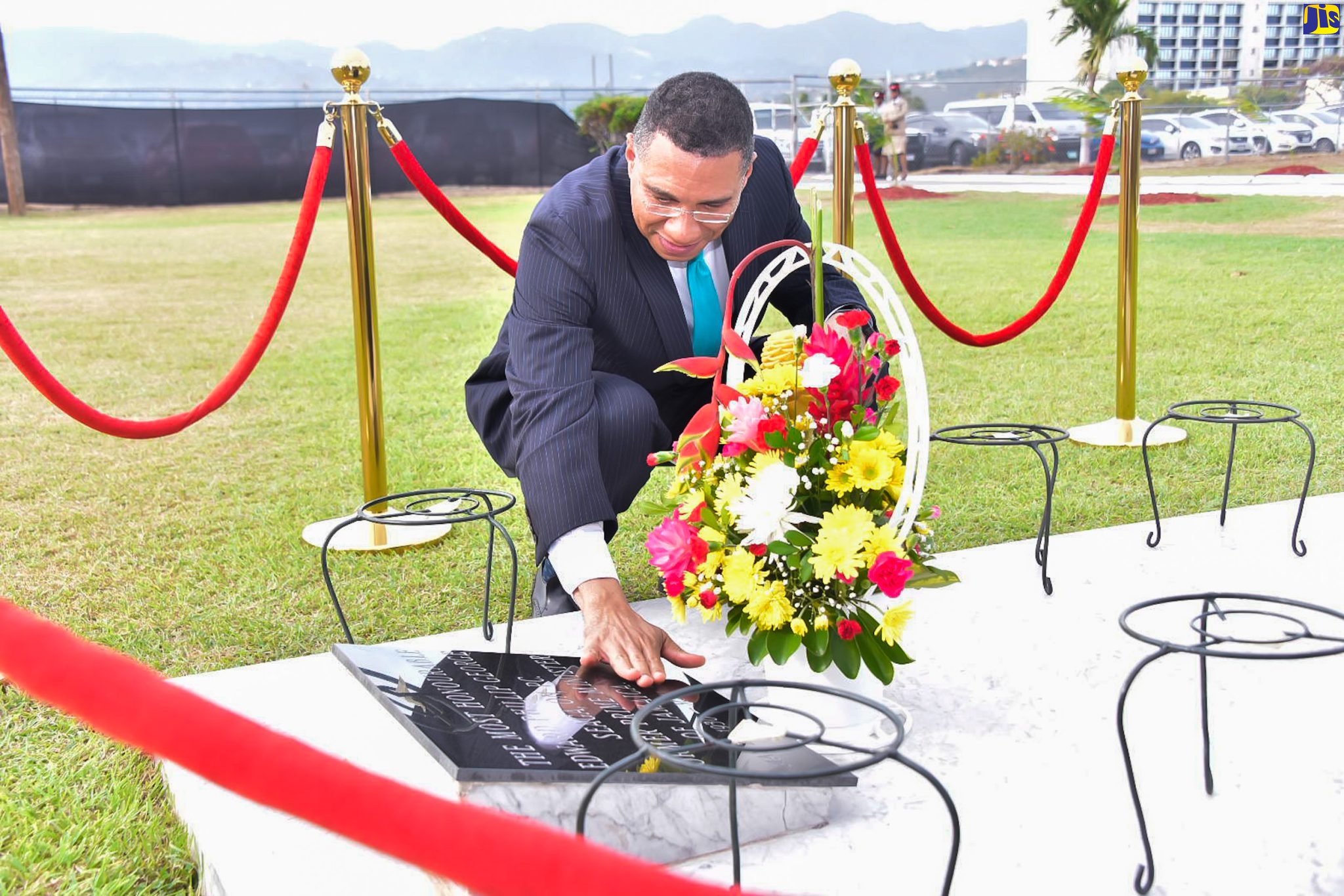 Prime Minister, the Most Hon. Andrew Holness, touches the headstone at the tomb of late former Prime Minister, the Most Hon. Edward Seaga, during a floral tribute to commemorate the 93rd anniversary of his birth, at National Heroes Park in Kingston, on Sunday (May 28).