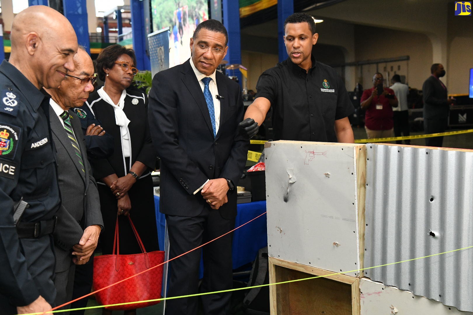 Prime Minister, the Most Hon. Andrew Holness (second right), listens as Forensic Ballistics Expert, Assistant Superintendent of Police, Miguel Bernard (right), outlines details of the science. Also listening are Police Commissioner, Major General Antony Anderson (left); and Deputy Prime Minister and Minister of National Security, Hon. Dr. Horace Chang (second left). The event was the opening ceremony for the Jamaica Constabulary Force’s (JCF) ‘Transformations 2023: People, Quality and Technology Expo’, on Thursday (May 11) at the National Arena in Kingston. 