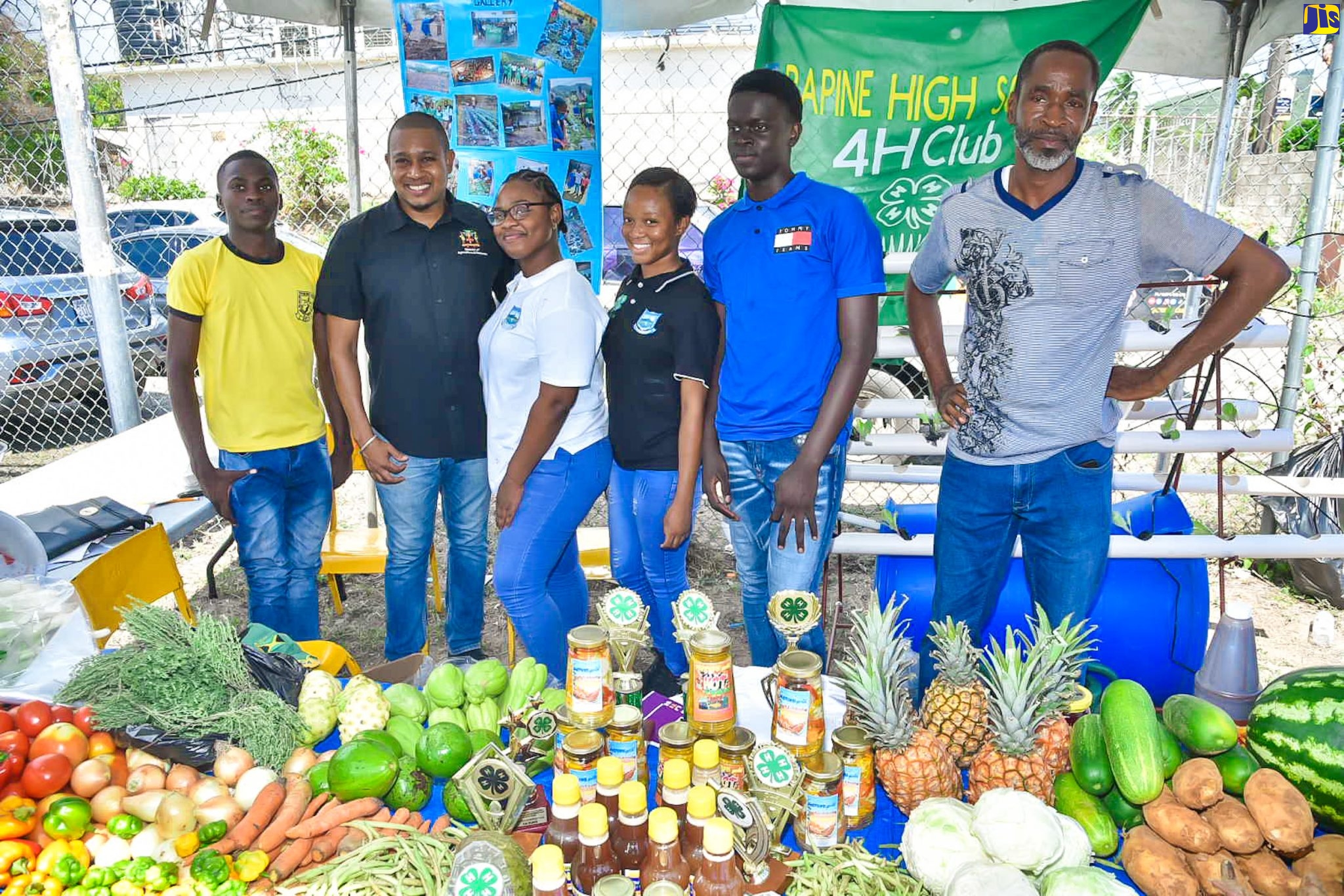 Minister of Agriculture, Fisheries and Mining, Hon. Floyd Green (second left), with representatives from the Papine High School 4-H Club during the 2023 Agricultural Show (Agrofest) for Kingston and St. Andrew. They are (from left) students, Andrew Matthewson, Grade 10; Jessica Williamson, Grade 11; Rihanna Simpson, Grade 11, and Terome Rookwooe, Grade 10; and Agricultural Science teacher, Mark Jones. The event was held on the Ministry’s playfield in Kingston, on Saturday (May 27).