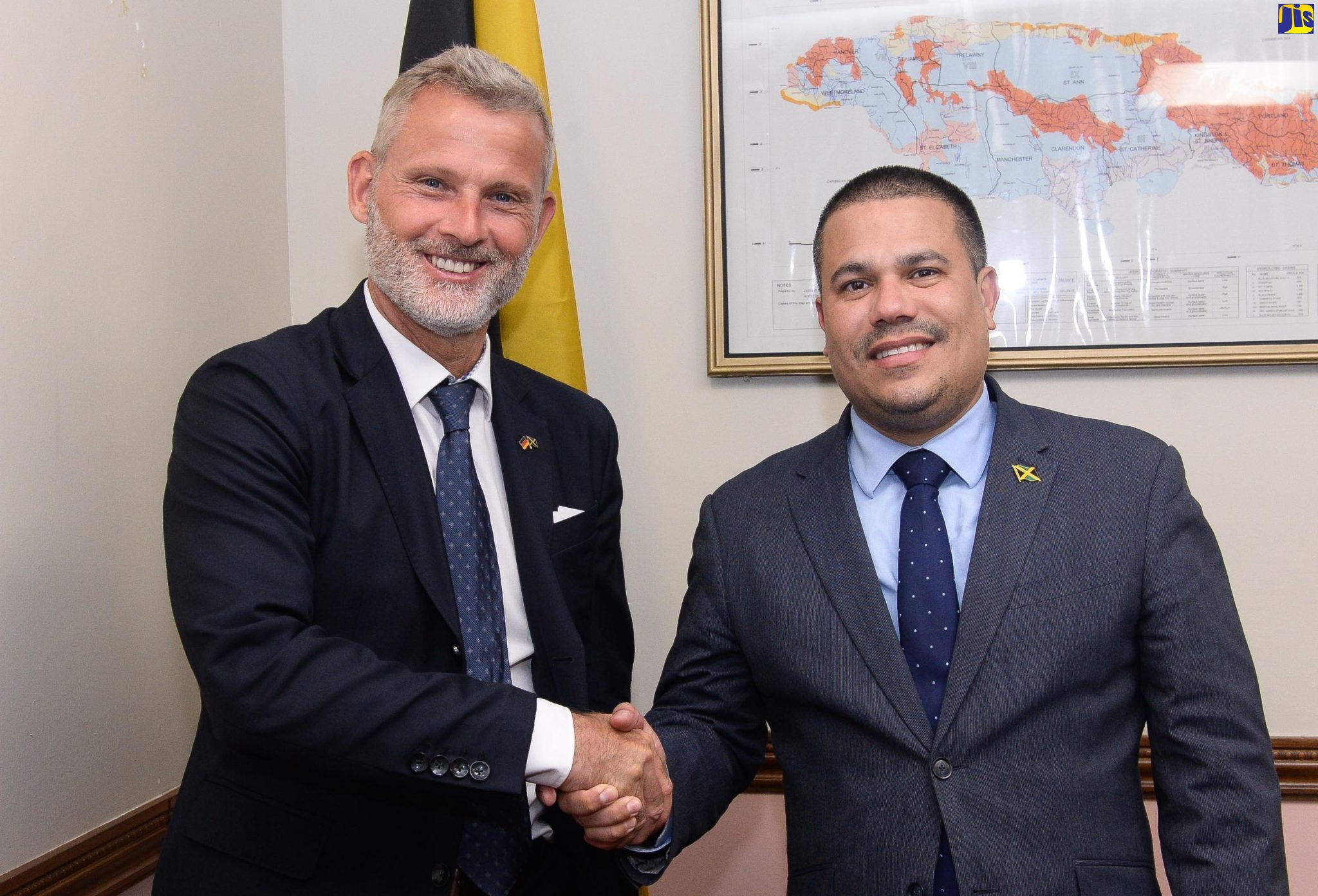 Minister without Portfolio in the Ministry of Economic Growth and Job Creation, Senator the Hon. Matthew Samuda (right), shakes hands with Ambassador of Germany to Jamaica, His Excellency Jan Hendrik van Thiel, during a courtesy call by the Ambassador at the Ministry’s offices in St. Andrew on May 2.