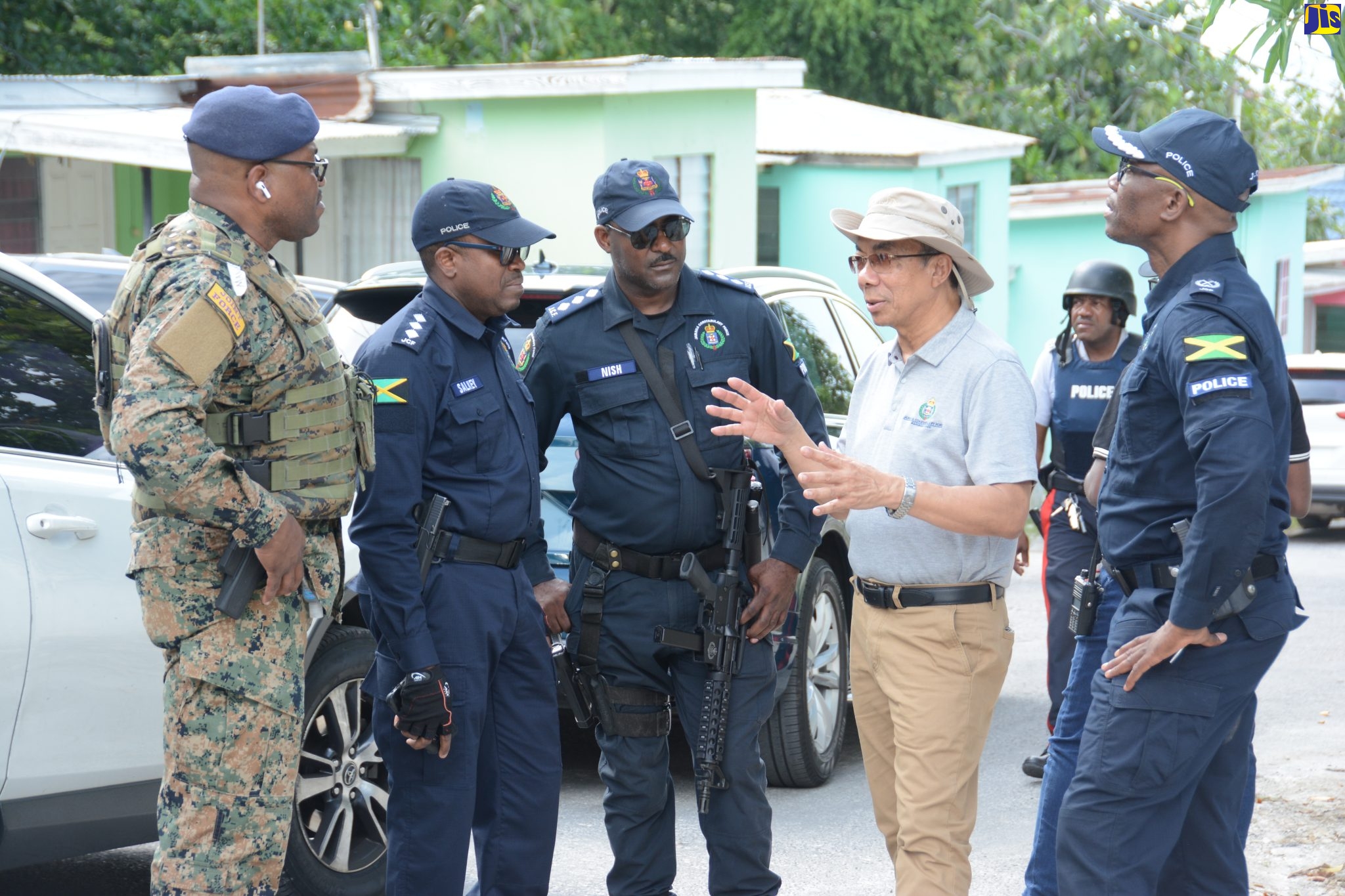 Deputy Prime Minister and Minister of National Security, Hon. Dr. Horace Chang (second right), converses with (from left) the Jamaica Defence Force’s (JDF) Major Anthony Lysight; Deputy Superintendents of Police (DSP) Peter Salkey and Andrew Nish, and Head of the Jamaica Constabulary Force’s (JCF) Area One, Assistant Commissioner of Police (ACP) Clifford Chambers, during a tour of Crabwood Lane in Hopewell, Hanover, on Saturday (May 13). 