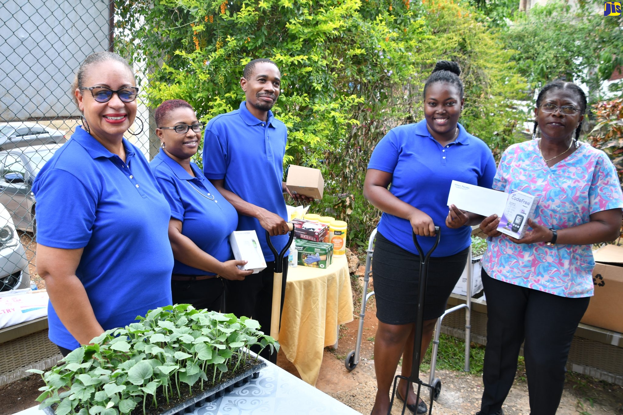 Members of Team Elevation, project management students from the Vocational Training Development Institute (VTDI), hand over supplies to Shelter Manager of the Refuge of Hope Shelter, Junice Woolery-Norman (right), at the facility on Wednesday (May 3). Team Elevation group members (from left) are Carol Heron-Meggo, Nickesha Samuels, Marlon Mitchell and Keyna Darling.
