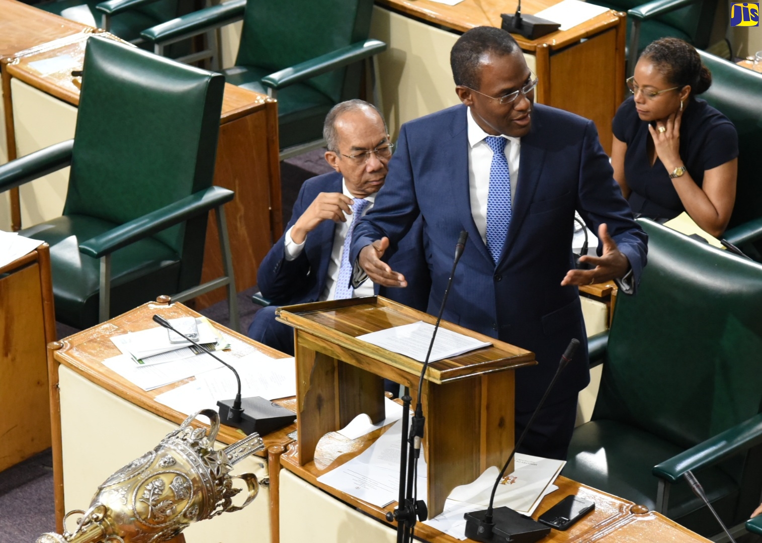 Minister of Finance and the Public Service, Dr. the Hon. Nigel Clarke, emphasises a point while addressing the House of Representatives on Tuesday (May 16). Listening are Deputy Prime Minister and Minister of National Security, Hon. Dr. Horace Chang (left) and Minister of Legal and Constitutional Affairs, Hon. Marlene Malahoo Forte. 