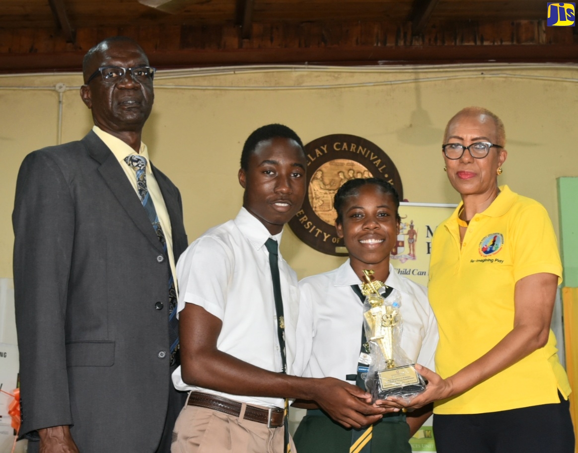 Minister of Education and Youth, Hon. Fayval Williams (right) presents the winning trophy in the 