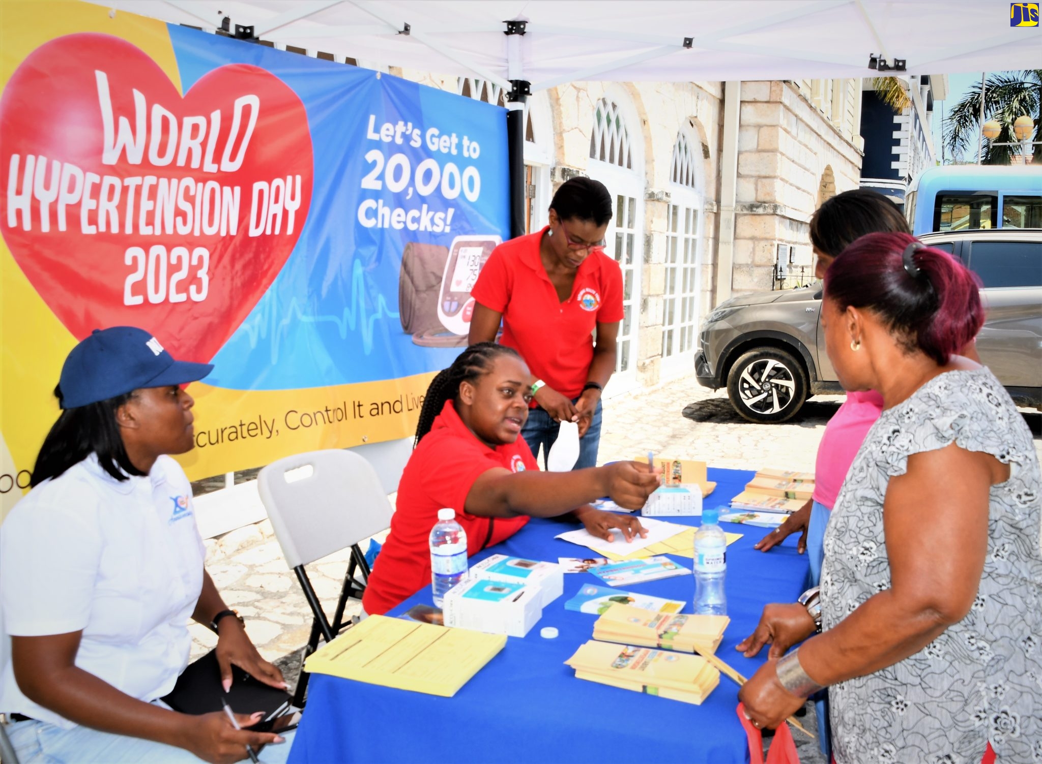 The National Health Fund (NHF) team provides instructions to members of the public during a free blood pressure check exercise in Sam Sharpe Square, Montego Bay, on Wednesday (May 17), to mark World Hypertension Day. 