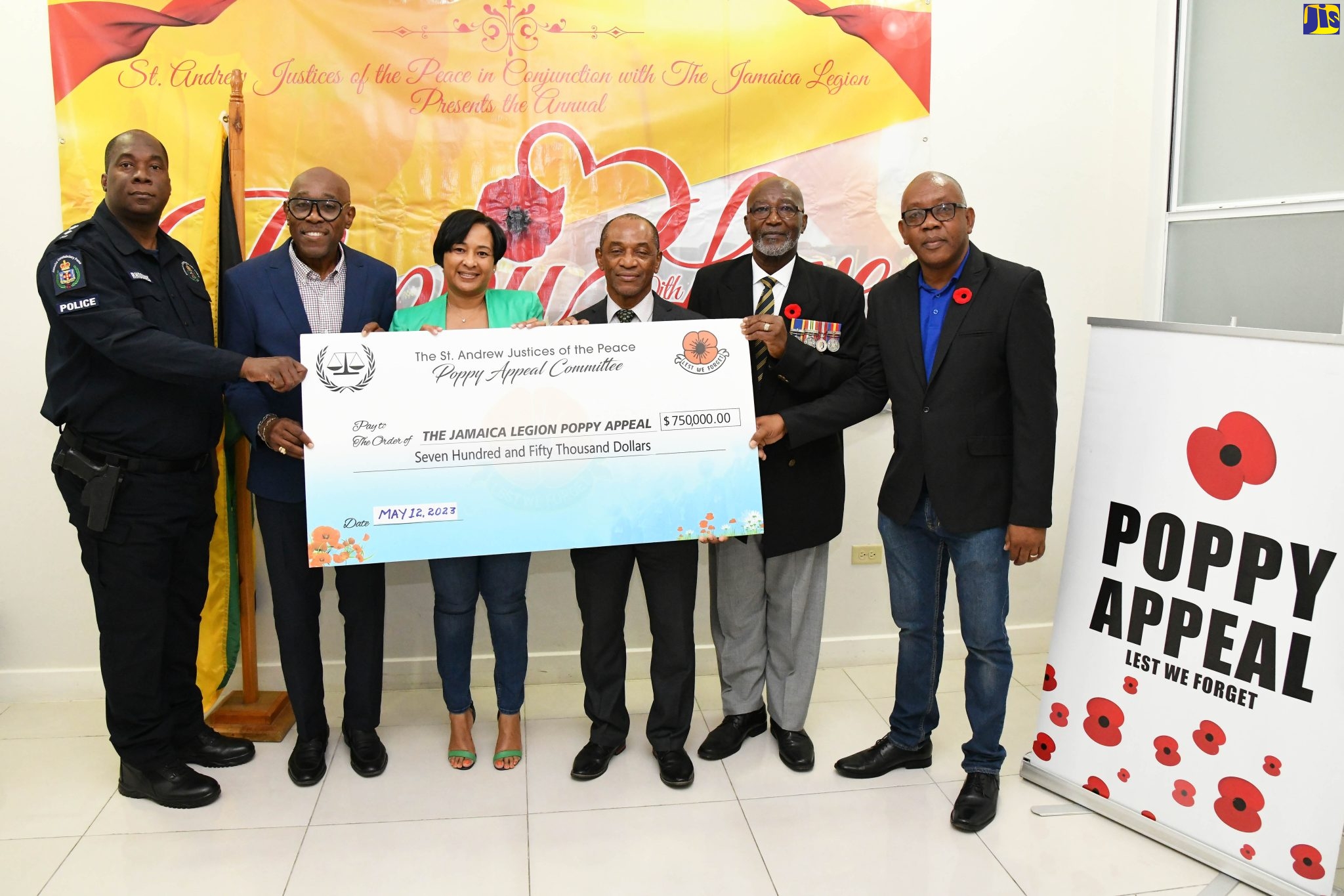 Custos Rotulorum for St. Andrew and Chairman, Jamaica Legion Poppy Appeal, Hon. Ian Forbes (second left), and fellow stakeholders display a symbolic cheque, in the sum of $750,000, which was presented for the procurement of a water heater for the Curphey Home for ex-servicemen and women in Manchester. The funds were donated by the Office of the Custos Rotulorum through the Jamaica Legion Poppy Appeal. The presentation was made on Friday (May 12) at Mr. Forbes’ office. Others (from left) are Chairman, St. Andrew Justices of the Peace, Senior Superintendent of Police Norris Rhoomes; Chair, Jamaica Legion Poppy Appeal, St. Andrew Chapter, Michelle Henry; and Jamaica Legion Poppy Appeal executives, General Secretary, Lt. Col. Michael Anglin, Vice Chairman, Errol McKenzie, and Coordinator, Andy Miller.