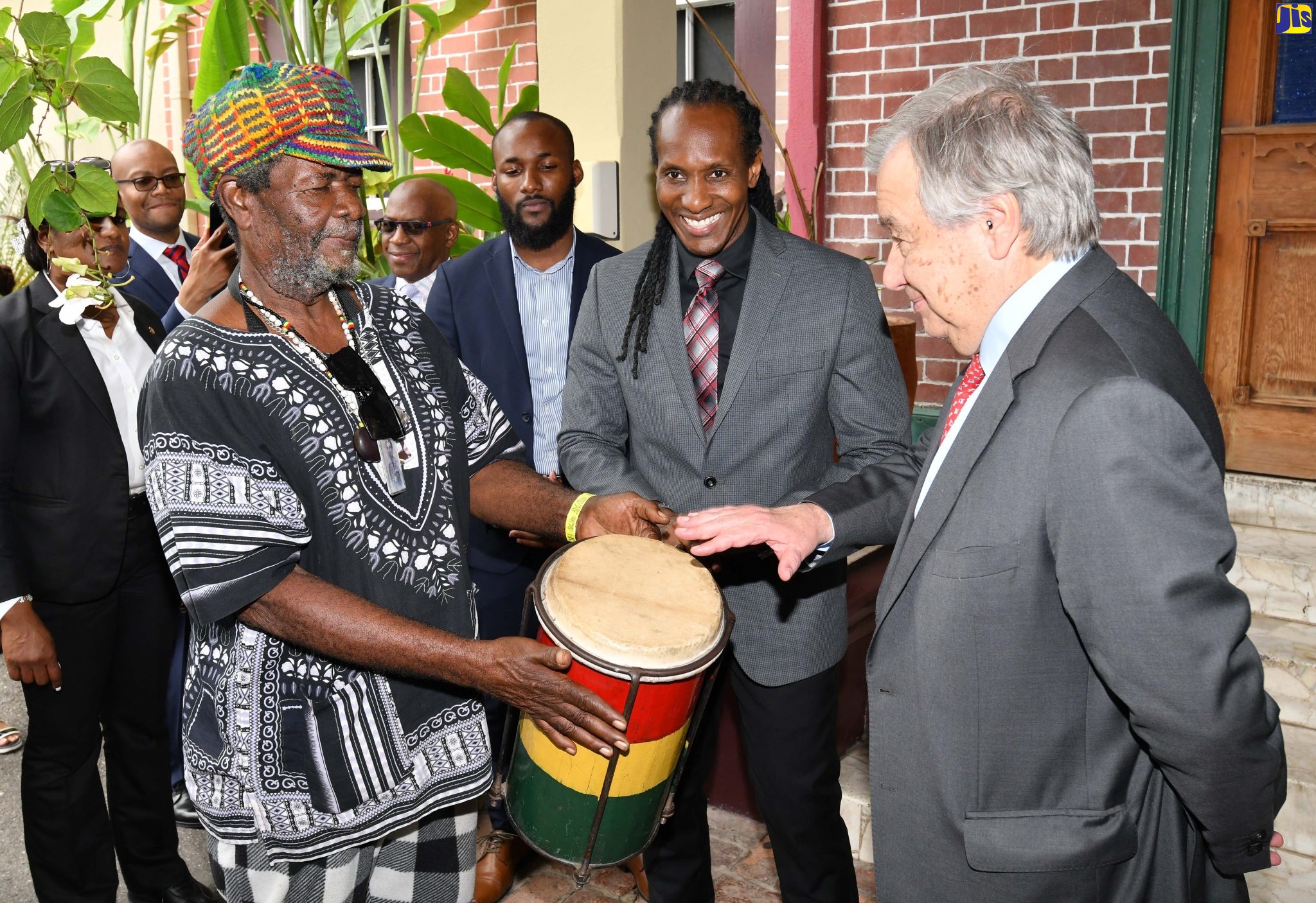 United Nations (UN) Secretary-General, His Excellency, António Guterres (right), tries his hand at drumming under the instruction of noted drummer, Herman Davis, aka “Bungo Herman” (left). Enjoying the moment is State Minister in the Ministry of Culture, Gender, Entertainment and Sport, Hon. Alando Terrelonge (centre). The Secretary-General and members of the UN and Ministry teams conducted a tour of the Bob Marley Museum on Hope Road, St. Andrew, on May 15. 