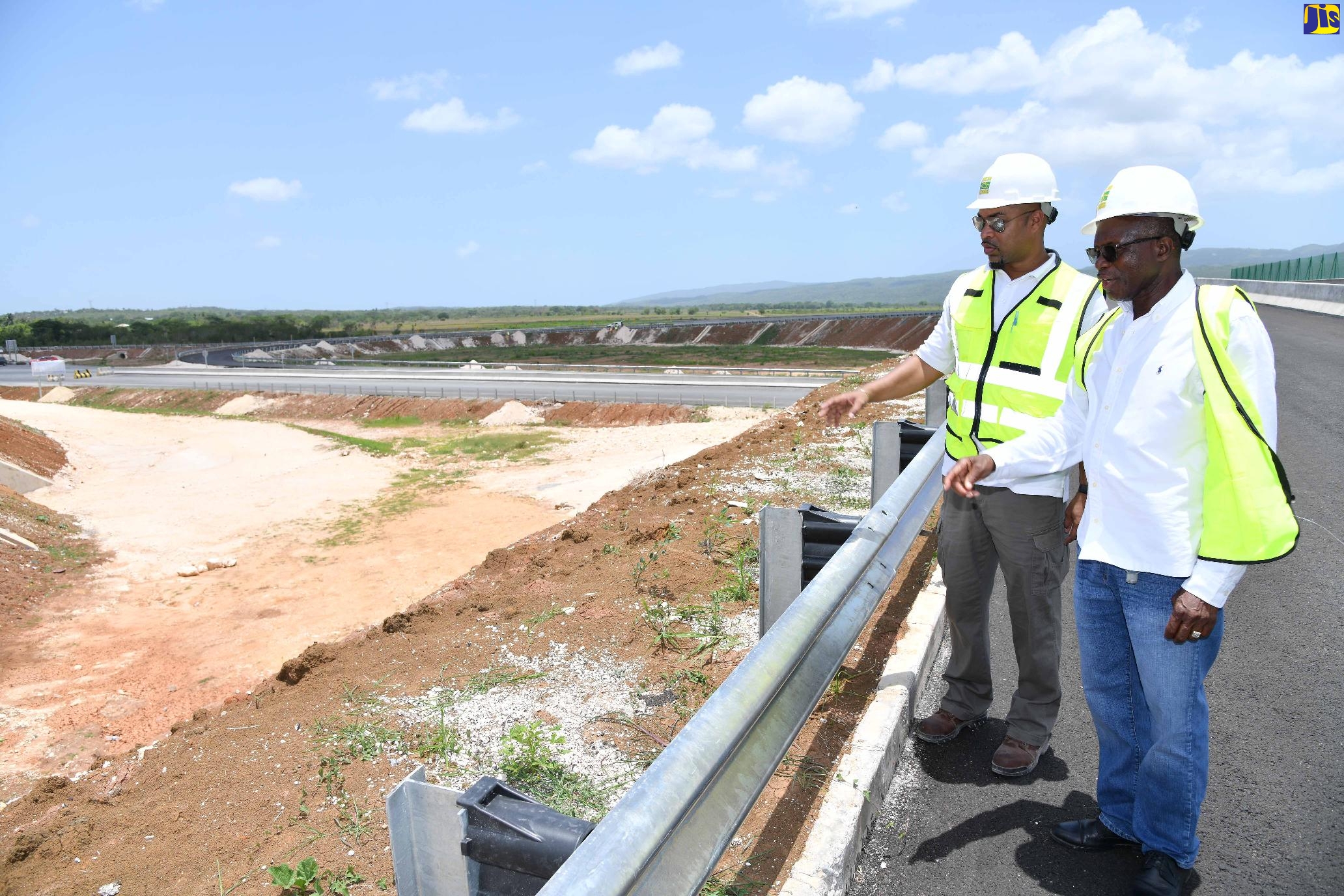 Minister Without Portfolio in the Ministry of Economic Growth and Job Creation, Hon. Everald Warmington (right) and Managing Director, National Road Operating and Constructing Company Limited (NROCC), Steven Edwards, look at a section of the Melrose Hill Interchange during a tour of  the May Pen to Williamsfield (Phase A) leg of the Southern Coastal Highway Improvement Project (SCHIP) on Thursday (May 11). 