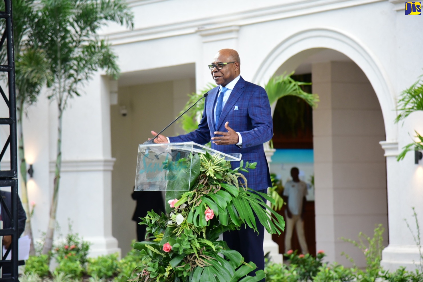 Minister of Tourism, Hon. Edmund Bartlett, addresses the official opening ceremony for the new Sandals Dunn’s River Hotel in St. Ann, on May 19.