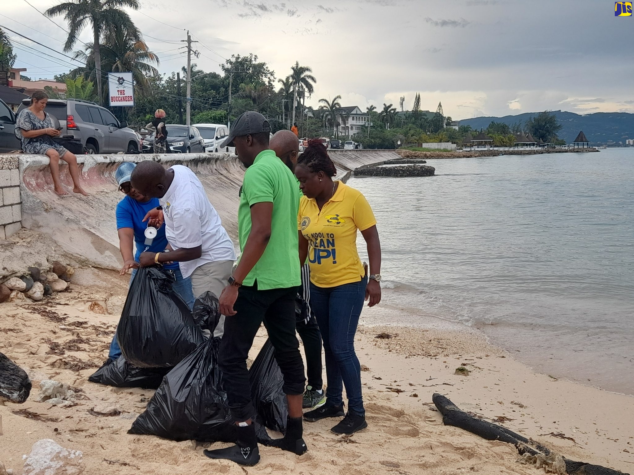 Executive Director of the National Solid Waste Management Authority (NSWMA), Audley Gordon (second from left), assists a volunteer in weighing a bag of plastic waste, which was removed from Dead End Beach in St. James during World Oceans Day clean up on Thursday (June 8). Other volunteers wait to weight bags of garbage. The day’s activities, which included clean up of the Fisherman’s Beach, was spearheaded by WPM Waste Management Limited.