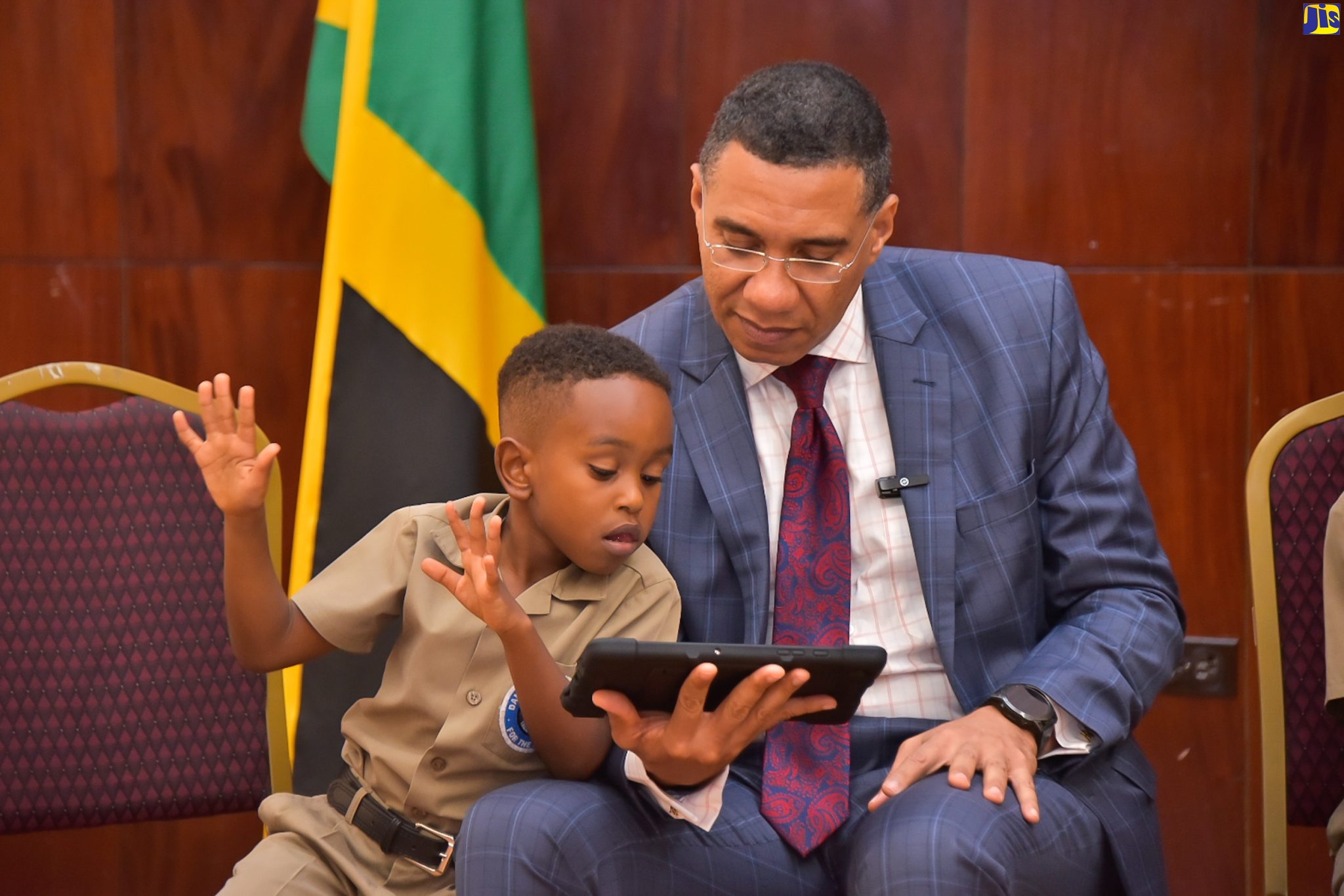 Prime Minister, the Most Hon. Andrew Holness, looks on as six-year-old Ari from the Danny Williams School for the Deaf, signs while using an assistive learning device to read. Occasion was a courtesy call at Jamaica House on May 30, to present the Accessible Digital Textbook Project to the Prime Minister. The initiative is a collaboration between the United Nations Children’s Fund (UNICEF) and Book Fusion, to provide children with access to high-quality, interactive digital textbooks to enhance learning.