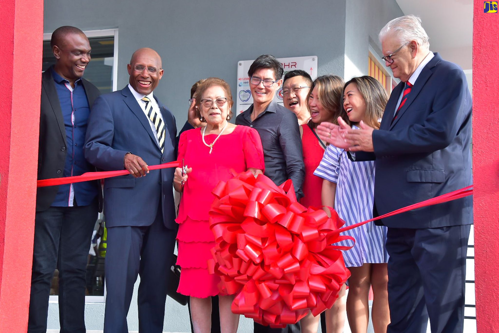 Minister of Industry, Investment and Commerce, Senator the Hon. Aubyn Hill (second left), and Member of Parliament for St. Andrew North Central, Karl Samuda (right), celebrate as matriarch of the Lee Family, Icyline Lee (third left) cuts the ribbon to officially open the 76 RHR Business Centre in Kingston on Wednesday (May 31). Also sharing the moment are (from left) AVP Service Delivery and Country Manager, Sutherland Global, Claude Duncan and Directors of the Lee’s Group – Patrick Lee, Ronald Chai, Sharon Lee-Hendrickson, and Sarah Chai.