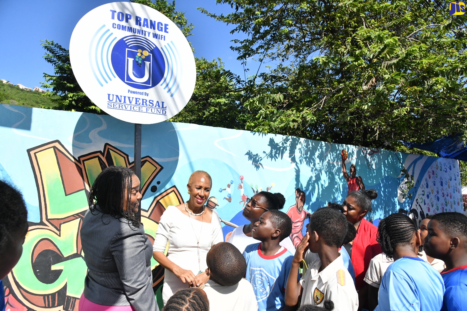 Minister of Education and Youth and Member of Parliament for St. Andrew Eastern, Hon. Fayval Williams (second left), interacts with students and other stakeholders following the official commissioning of Wi-Fi service in the community of Top Range in St. Andrew recently.