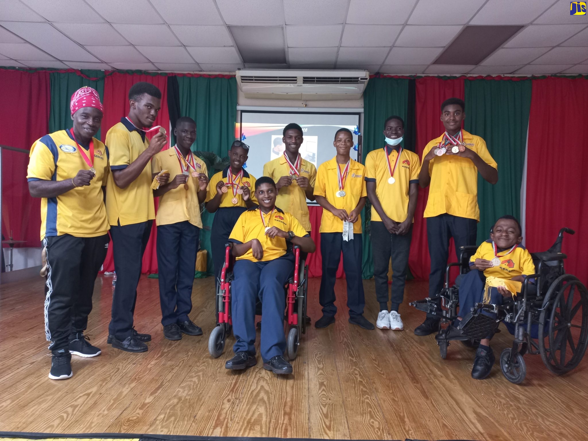 Members of Genesis Academy’s sports team, which copped over 20 medals and ribbons at the Special Olympics Jamaica National Games in Kingston. From left are Coach, Wayne Roberts; Nickoi Jones; Delano Gunter; Britany Martin; Omario Christian; Coyou Allen; Mathew Pusey; Brandon Graham; Assistant Coach, Dane Brown; and Maurice Dyer (centre). 