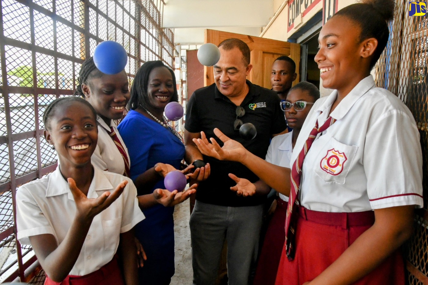 Minister of Health and Wellness,  Dr. the Hon. Christopher Tufton (centre), engages in a stress-relief exercise with students of Denham Town High School in Kingston on Tuesday (June 6) as part of the Ministry’s School Mental Health Literacy Programme. Joining in the activity is Guidance Counsellor of the school, Dawn Scott-Turner (third left).