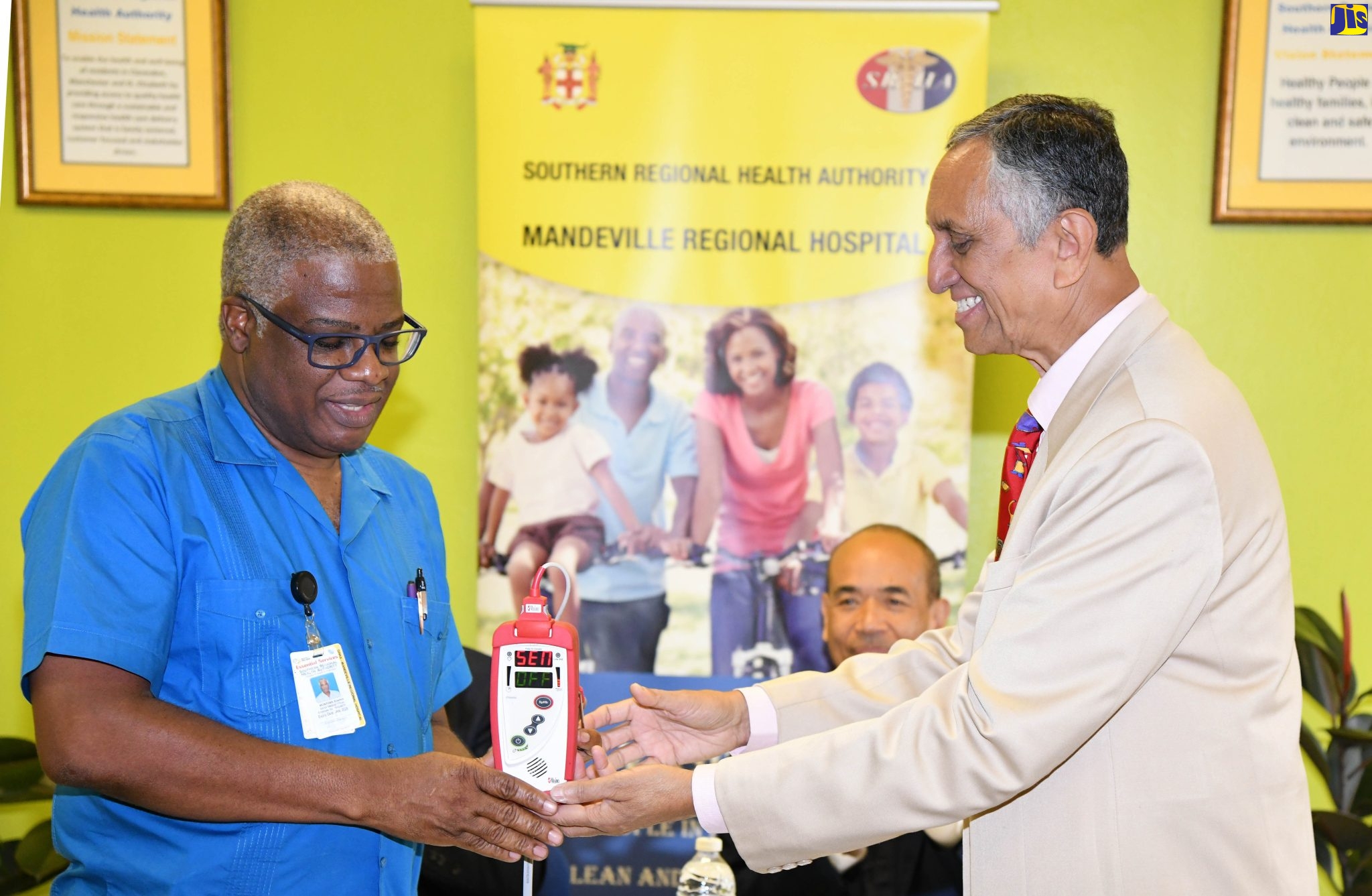 Senior Medical Officer for the Mandeville Regional Hospital, Dr. Everton McIntosh (left), receives a pulse oximeter from Dr. Nitin Shah, Mission Leader for the Mind Body and Soul Health Ministry, at the hospital on June 20.