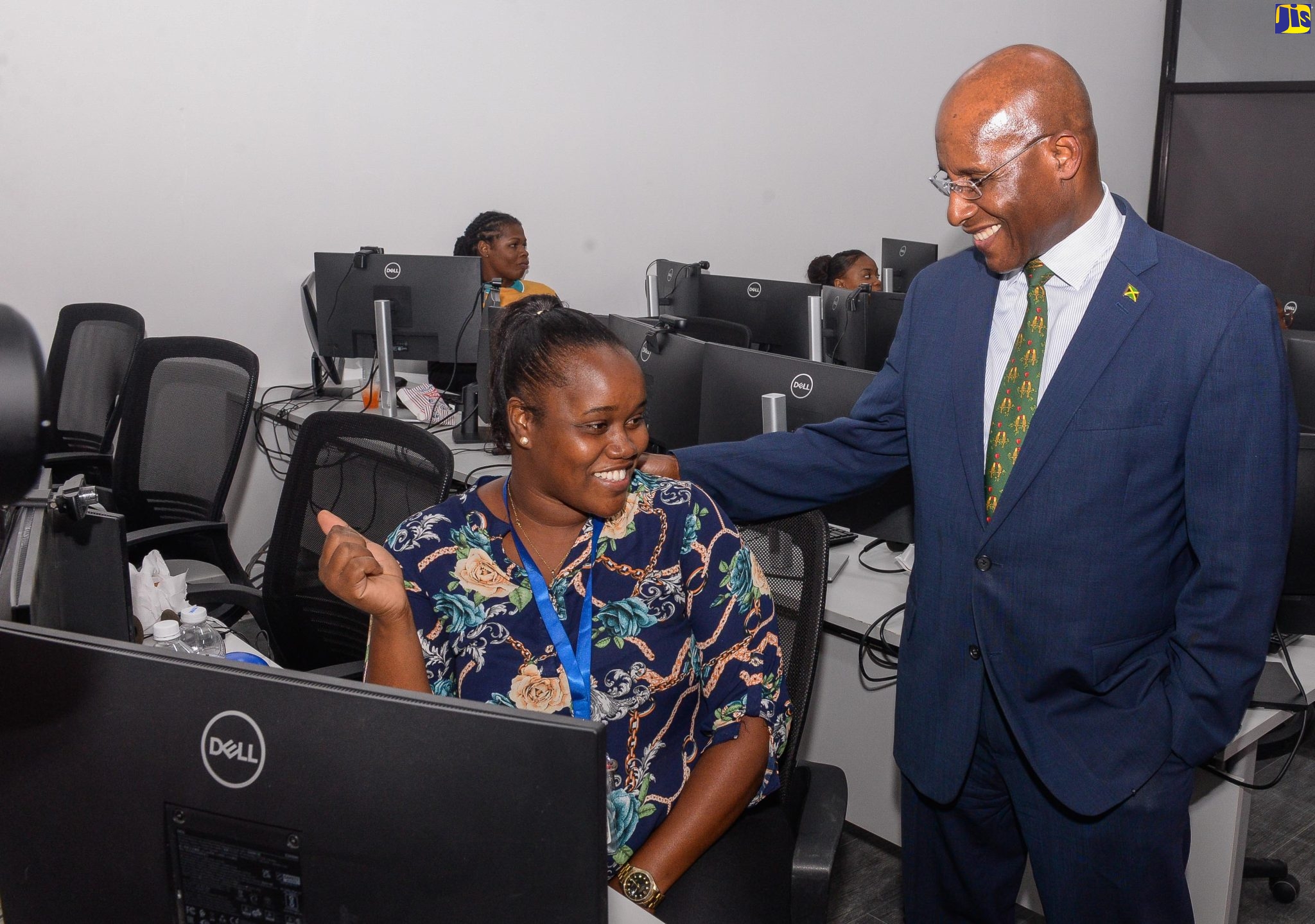 Minister of Industry, Investment and Commerce, Senator the Hon. Aubyn Hill (right) engages with employee at Sagility,  Christena Henry, during a tour of the global service provider’s new site in Angels, St. Catherine, at the official opening on Tuesday (June 6).