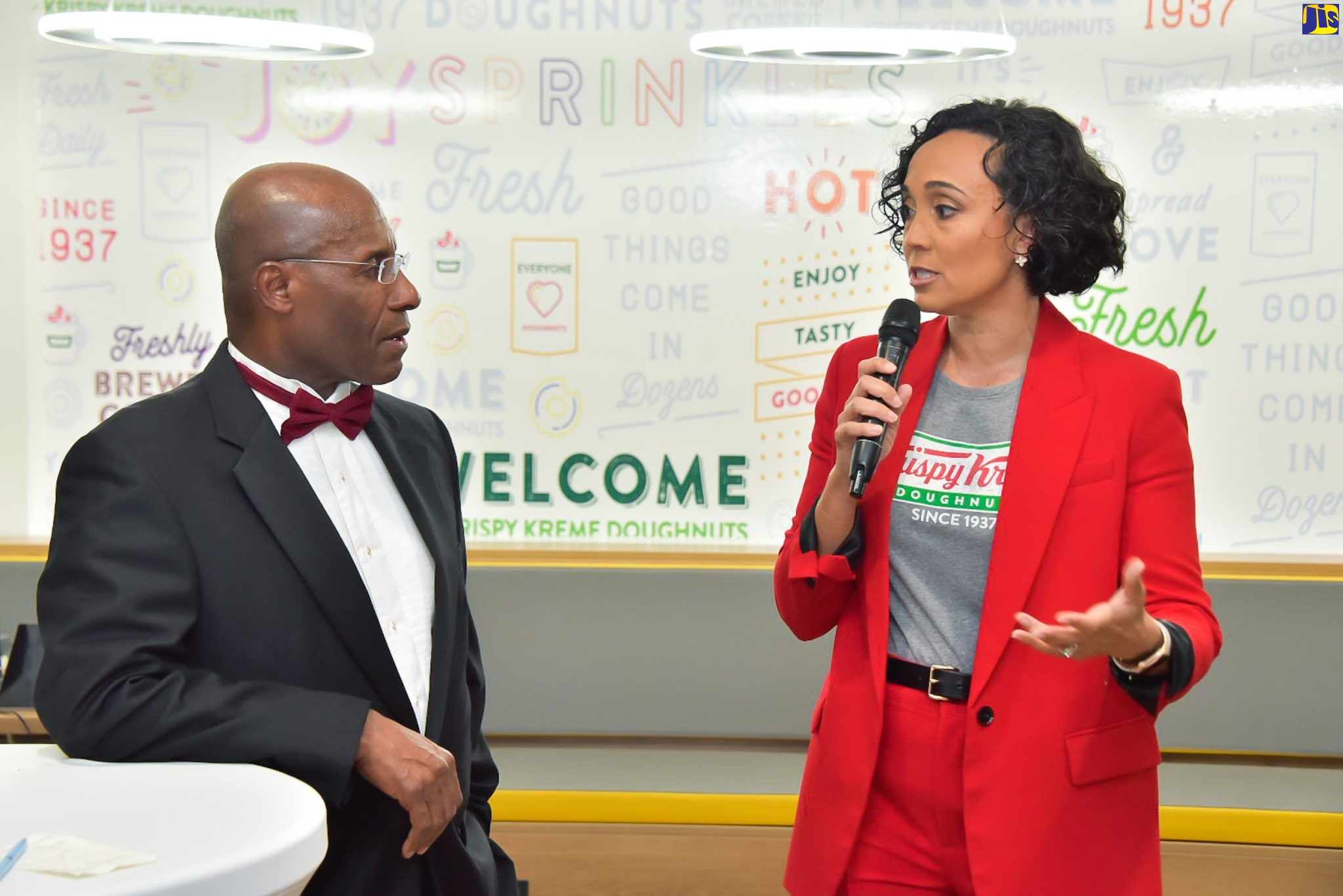 Minister of Industry, Investment and Commerce, Senator the Hon. Aubyn Hill (left), listens to remarks by Group Chief Executive Officer of Restaurant Associates Limited (RAL), Lisa Lake, during the prelaunch of Krispy Kreme on Waterloo Road in St. Andrew on May 31. RAL is the local franchise holder of Krispy Kreme.