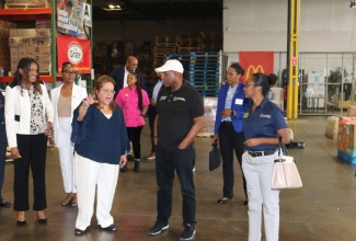 Minister of Industry, Investment and Commerce, Senator the Hon, Aubyn Hill (third right), listens as President of EMD Sales, Elda Devarie (third left), outlines aspects to the company’s operations. Listening are President of Jamaica Promotions Corporation (JAMPRO), Shullette Cox (right) and other members of the Jamaican delegation. The Minister toured the company’s facility in Baltimore, Maryland, during his recent visit to Washington DC. EMD Sales is the largest distributor of Jamaican products in the Maryland and Washington DC area.
