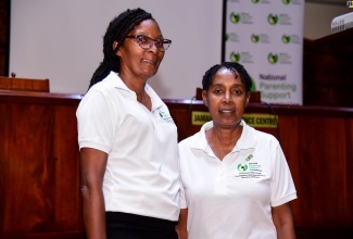 Parent mentors Colette Fairclough-Thorpe (right) and Patricia Ferguson (left), at the parent-training and information session on Transformation in Education, hosted by the National Parenting Support Commission (NPSC), on Thursday (August 3), at the Jamaica Conference Centre in downtown Kingston.
