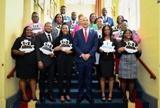 Governor-General, His Excellency the Most Hon. Sir Patrick Allen (front row, third right), is flanked by the 2023 recipients of the Marcus Garvey Public Sector Scholarship during Thursday’s (August 17) awards ceremony at King’s House. Nineteen public-sector employees have been awarded scholarships to pursue masters or doctoral studies at an approved local and or international university.