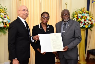 Governor-General, His Excellency, the Most Hon. Sir Patrick Allen (left), displays the Proclamation declaring Friday (June 23) as the National Day of Mourning for Jamaica’s Children, which was read during a ceremony at King’s House on Wednesday (June 1). With him are Chair, Jamaica Umbrella Group of Churches (JUGC), Dr. Elaine McCarthy (centre) and Custos Rotulorum for St. James, Bishop the Hon. Conrad Pitkin.