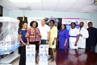 Minister of Health and Wellness, Dr. the Hon. Christopher Tufton (third left), receives a donation of Maternal Care Equipment to the Victoria Jubilee Hospital, from the Bob and Rita Marley Foundation, during a visit at the Ministry’s offices in Kingston on July 7. Others present at the handover are (from left) Representative from the Foundation, Mitzie Williams; Foundation Manager, Alicia Williams; Director, Health Services and Planning Integration at the hospital, Dr. Naydene Williams; Deputy Director of Nursing Services, Candice Thompson; Mid-Wife, Taision Lawrence-Tyrell; Senior Medical Officer, Dr. Garth McDonald; and Director of National Healthcare Enhancement Foundation, Courtney Cephas.