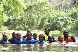 Cadets from across the Caribbean practise basic water techniques with their instructors, Lieutenant (Junior Grade) Davor Bonilla of the Cayman Islands Cadet Corps (right, back row) and Petty Officer Jamaal Newton-Bryant of the Jamaica Combined Cadet Force (right, front row). They are attending Caribbean Cadet Camp 2023, being held at Clarendon College.