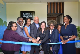 Minister of Justice, Hon. Delroy Chuck (fourth left) along with Chargé d’Affaires, United States Embassy, Amy Tachco (fourth right) cut the ribbon to officially open the child-friendly space at the Victim Services Branch office in Mandeville, Manchester on August 18. Sharing the moment (from left) are Permanent Secretary in the Ministry of Justice, Mrs. Grace Ann Stewart McFarlane; Custos of Manchester, Hon. Garfield Green; Member of Parliament for Manchester Central, Rhoda Moy Crawford; Warnath Group Country Project Director, Aylair Livingston; Manager, Trafficking Secretariat, Ministry of Justice, Audrey Budhi; and Children's Advocate, Diahann Gordon Harrison.