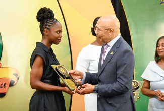 Governor-General, His Excellency the Most Hon. Sir Patrick Allen (right), presents a plaque to a recipient of the Governor-General’s Achievement Awards (GGAA), Dr. Rodean Sylvester, at the 2023 National Presentation Ceremony held at King’s House on Thursday (June 29). The St. Ann native was recognised for her academic excellence, leadership and community service.