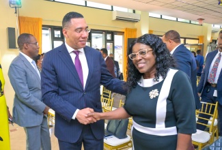 Prime Minister, the Most Hon. Andrew Holness (left), greets newly appointed Cabinet Secretary, Audrey Sewell, during the Office of the Prime Minister’s quarterly press briefing on Thursday (August 3).