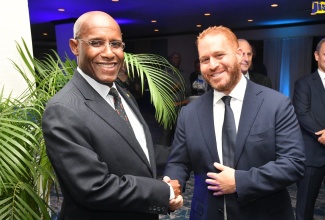 Minister of Industry, Investment and Commerce, Senator the Hon. Aubyn Hill (left), with Chief Executive Officer, ANSA McAL Group of Companies, Anthony N. Sabga III, during a reception hosted by the company for local business stakeholders on Thursday (July 6) at The Jamaica Pegasus hotel in New Kingston.