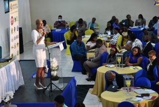Minister of Education and Youth, Hon. Fayval Williams (at podium), addresses stakeholders at the Region Five Back-to-School Conference held at the Golf View Hotel in Manchester recently.