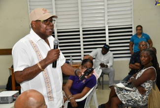Minister of Tourism, Hon. Edmund Bartlett, addresses a stakeholder meeting at the Anglican Church Hall in Morant Bay, St. Thomas, during a recent destination assurance tour of the parish.