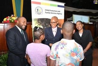 Minister of Education and Youth, Hon. Fayval Williams (centre), congratulates wards of the State on emerging as top performers in the 2023 Primary Exit Profile (PEP) examinations. Sharing in the celebration are State Minister in the Ministry of Education and Youth, Hon. Marsha Smith (right), and Child Protection and Family Services Agency (CPFSA) Director of Programmes, Dr. Warren Thompson (left). The occasion was the CPFSA PEP Workshop and Awards Ceremony at the Jamaica Conference Centre in downtown Kingston on Wednesday (August 16).
