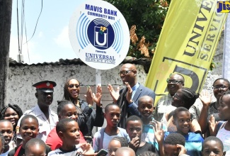 Member of Parliament for St. Andrew East Rural, the Most Hon. Juliet Holness (third left, back row), celebrates the launch of community Wi-Fi in Mavis Bank alongside (from second left) Sergeant Devon McFarlane of the Mavis Bank Police Station; Director of Projects, Universal Service Fund (USF), Jaime Robinson, and community members. The service was launched on Monday (August 21) at Mavis Bank square.